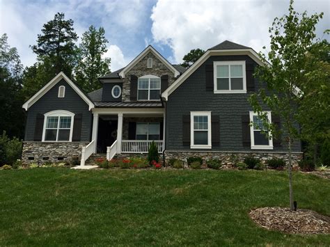 dark gray house with green metal roof|gray exterior with black trim.